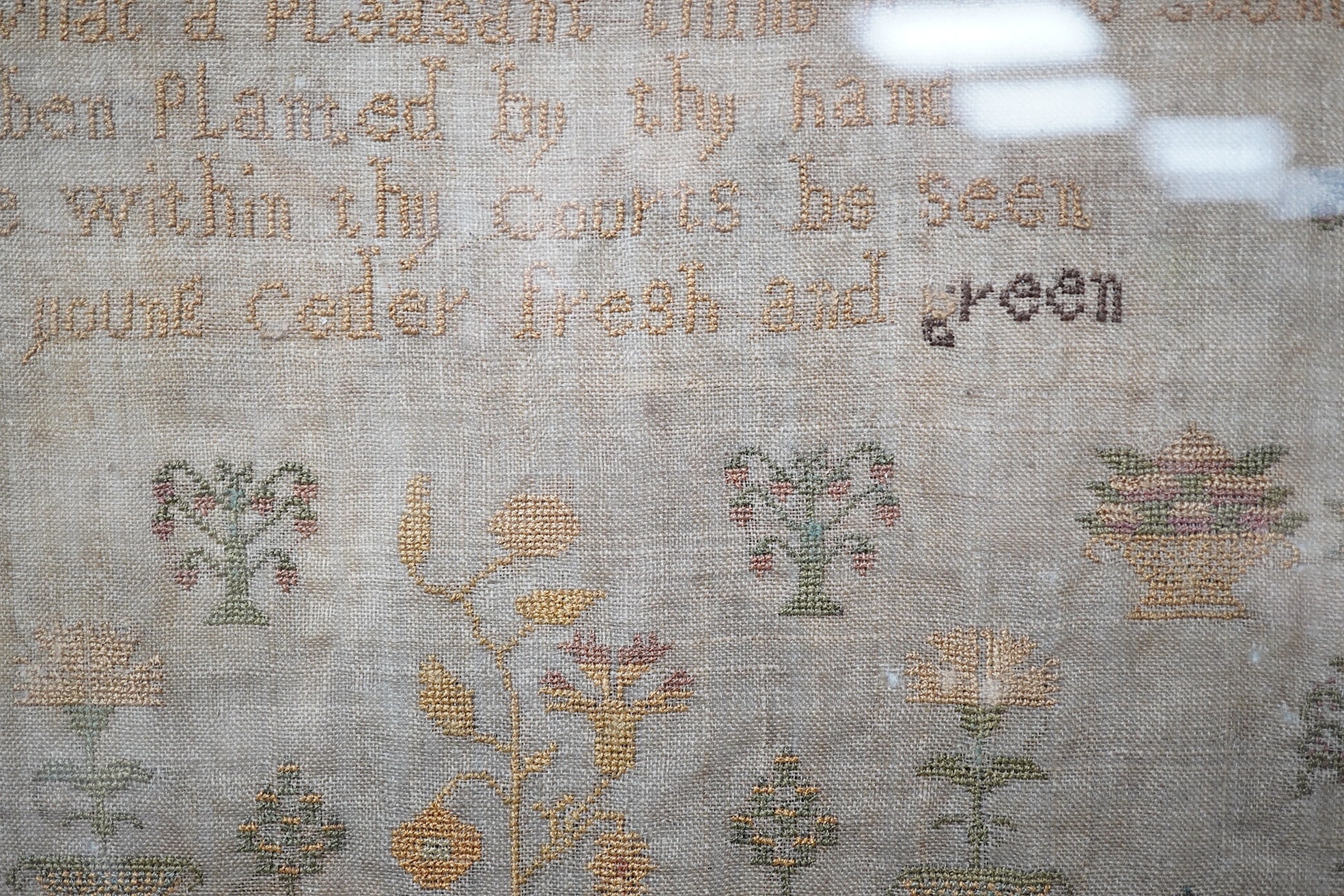 A sampler with spot motifs and central cartouche, embroidered with Ann Richardson, her work aged 14 years 1824. A very finely embroidered large spot sampler worked with motifs of stags, trees, planters of flowers with in